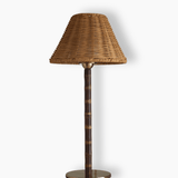 The Raffles cordless table lamp on a white background, showing the wicker shade, bamboo stem and round brass base