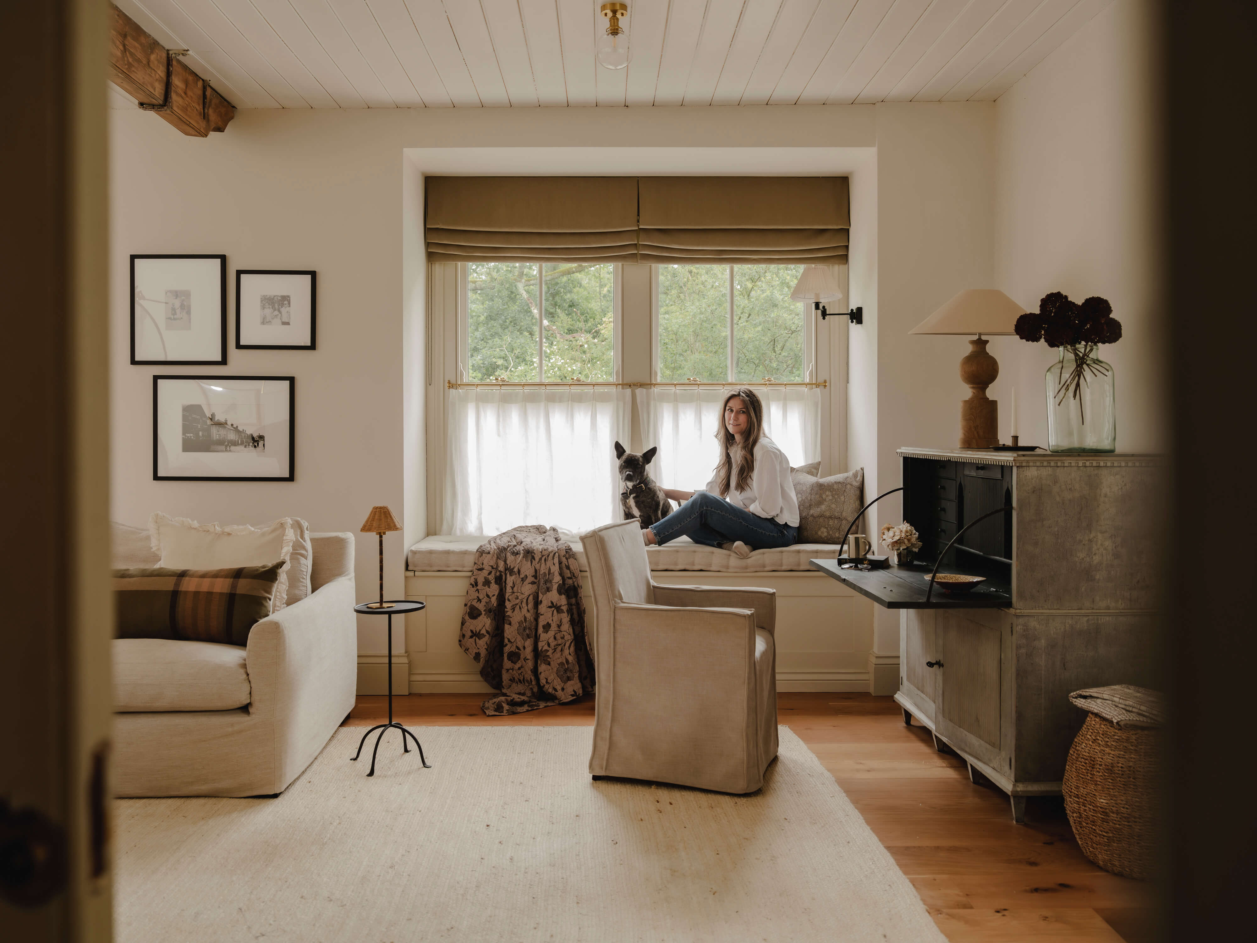 The Old And New Company's founder Jennifer sitting in her home with her dog to show their founder story and why they choice to set up the UK homeware brand