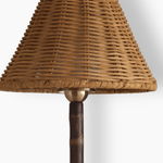 Close up of the Raffles lamp’s hand woven wicker shade and brass fitting on the bamboo stem