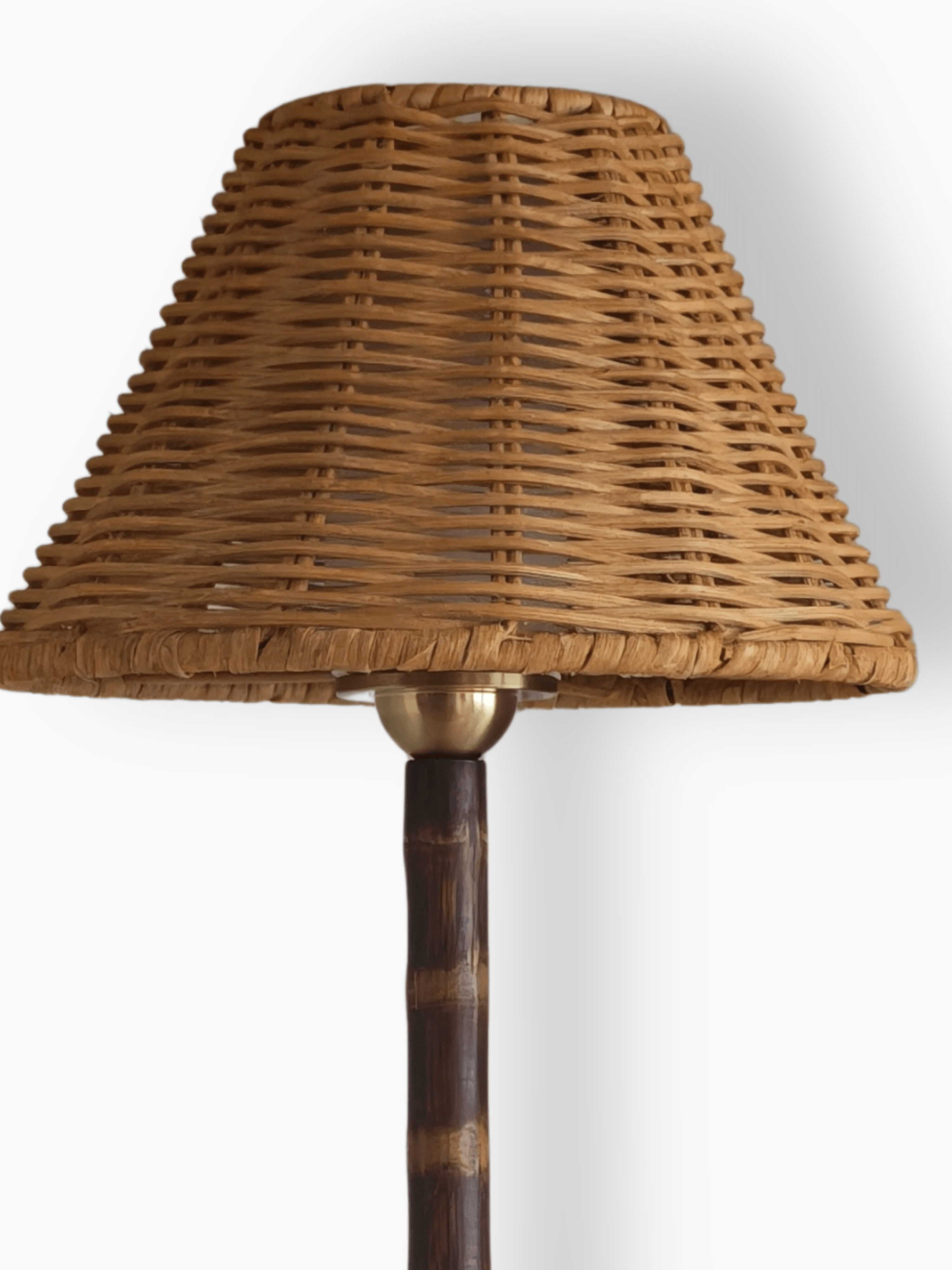 Close up of the Raffles lamp’s hand woven wicker shade and brass fitting on the bamboo stem