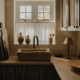 Wide view of a country kitchen with a stone sink, the Raffles rechargeable lamp at the end of the worktop