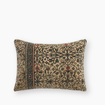 vintage kilim bolster cushion cover in greens and reds on a cream background
